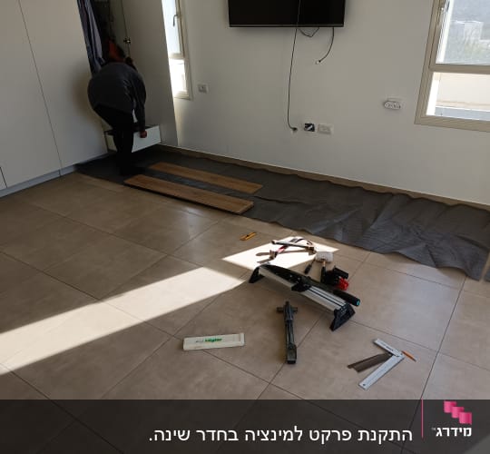 התקנת פרקט עם כלים וחומרים על הרצפה